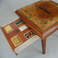 a wooden table with a board game on it's top and matching trays