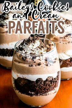 two glasses filled with desserts on top of a wooden table