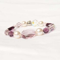 The Jane stretch bracelet is a lovely design for February and June birthdays or anyone that loves purple.  The large center rectangular faceted Light Amethyst center crystal is offset by stardust sparkle beads, dark and light amethyst crystals in various shapes and sizes, balinese beads, silver accents and pearls.  The necklace is strung on high quality jewelry grade elastic that makes it easy to slip on.  This is a beautiful bracelet to wear and pair with the Jane necklace or earrings. Elegant Purple Stretch Bracelet With Faceted Beads, Amethyst Crystal Bracelet, Bead Inspiration, Amethyst Birthstone, Amethyst Crystals, Purple Bracelet, Swarovski Crystal Bracelet, Swarovski Bracelet, Light Amethyst