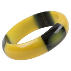 This piece is an outstanding Belle Kogan Bakelite elongated inlay dot bracelet bangle. The dots are set with a true licorice black surrounding color, in a light banana yellow color, and appear three times around the bangle. The bracelet has a domed shape and the same banana-yellow color. It is one of the rarer of Belle Kogan's designs. Measurements: Inside across 2.50 in diameter (6.3 cm) - outside across 3.07 in diameter (7.8 cm) - width is 0.82 in (2 cm) - the wall is 0.32 in (0.8 cm). The inner circumference of the bracelet is 7.79 in (19.78 cm). Feel free to double-check the measurements and ask any questions you have before making your purchase. This item is a final sale. No returns will be accepted for an unfit size. Banana Yellow, Bakelite Bracelets, Yellow And Black, Bracelet Bangle, Licorice, Yellow Color, Costume Jewelry, Diy Jewelry, Bangle Bracelets