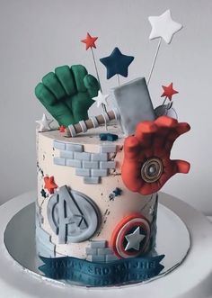 this is a birthday cake decorated with captain america symbols and iron man's fist