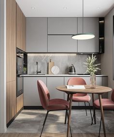 a dining table with four chairs around it in the middle of an open kitchen area