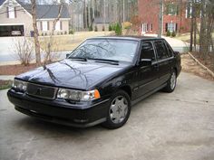 a black car is parked in the driveway