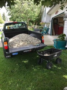 the truck is loaded with gravel and ready to go down the hill in the yard