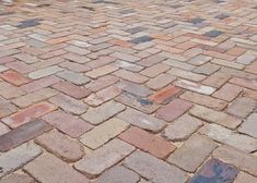 an image of a brick road that looks like it is made out of different colored bricks