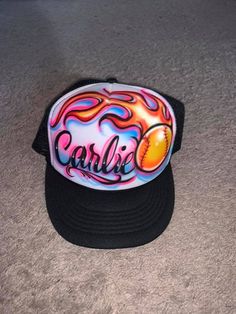 a cap with the word carib written on it and an orange ball in flames