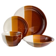 an orange and white striped dinnerware set