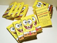 there are some spongebob birthday party favors on the table with yellow cards in front of them