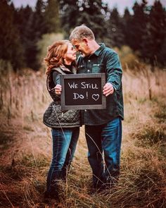 a man and woman holding a sign that says we still do love