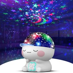 an adorable little toy sitting on top of a white table with stars in the background