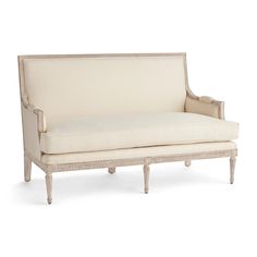 a white couch sitting on top of a wooden frame