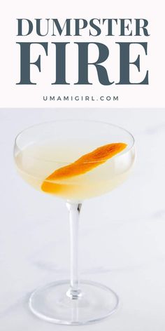 an orange garnish in a martini glass with the words dumpster fire on it