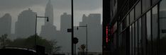 the city skyline is covered in heavy rain