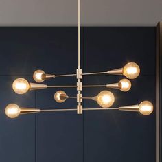 a modern chandelier with six lights hanging from it's center and four arms