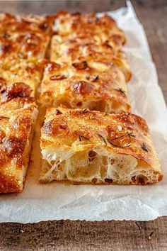 the bread is cut into squares and placed on top of wax paper, ready to be eaten