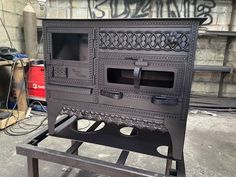 an old fashioned stove sitting on top of a table