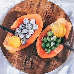 two pieces of fruit on a wooden plate