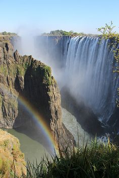 a rainbow in the middle of a waterfall