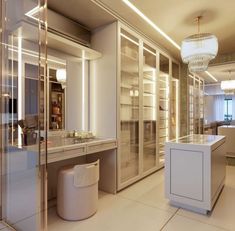 a large kitchen with white counter tops and cabinets