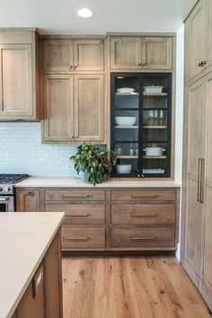 a kitchen with wooden cabinets and white counter tops