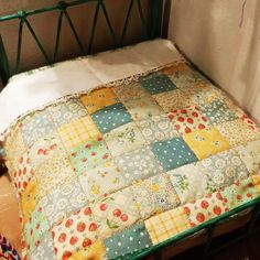 a bed with a quilt on top of it