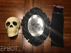 there is a skull and a mirror on the floor