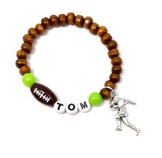 Personalized football player charm bracelet for boys or girls. Perfect as birthday favors. I should be able to customize more colors,depending on a current stock, send me a message. It can but doesn't have to be personalized, also send me a message or leave me a note at checkout. Bracelet will come in a random color organza bag ready for gift giving or keeping. If you need your item faster, please purchase priority shipping upgrade at the checkout. Personalized Team Spirit Stretch Bracelet As A Gift, Boys Bracelet, Bracelet For Boys, Boys Bracelets, Giants Football, Football Birthday, Wooden Bracelet, Personalized Football, Football Player