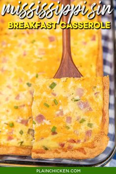 a casserole with ham and cheese on it is being held up by a spatula