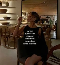 a woman sitting in a chair drinking from a wine glass with the words smart, successful, elegant, confident, mysterious, and very material