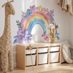 a child's room with a giraffe, rainbow and flowers on the wall