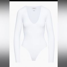 a women's white bodysuit with long sleeves and no bras on it