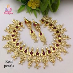 This is an exclusive high quality gold plated designer Indian wedding necklace studded with ruby and emerald stones with real tiny fresh water pearls and in a lotus flower motif. This precision-crafted necklace comes with matching pair of earrings and a complimentary gift box. The necklace is made 22k Gold plated copper, with High quality Cubic Zirconia and real Freshwater Pearls. This is a perfect gift for your beloved one and can be worn at any occasion to make you look more beautiful. This ne Anniversary Temple Jewelry With Pearl Drop, Ruby Jeweled Necklaces For Wedding, Gold Jeweled Pearl Necklace For Wedding, Oval Pearl Jewelry For Wedding, Elegant Gold Pearl Necklace For Marriage, Elegant Heavy Gold-plated Bridal Necklace, Oval Pearl Wedding Jewelry, Oval Gold Plated Necklace For Wedding, Kundan Bridal Necklace With Elegant Design