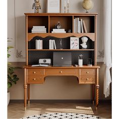 a wooden desk topped with a laptop computer next to a book shelf filled with books