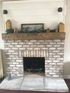 a brick fireplace in a living room with white walls