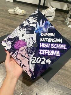 a hand holding up a purple and black graduation cap that reads,'domian extension high school diploma 2024 '