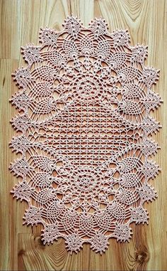 a pink doily sitting on top of a wooden floor