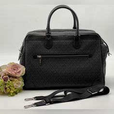 Michael Kors Travel Large Duffle/Weekender Bag In Pvc Signature (Black) With Trolley Sleeve Color: Black Signature Silver Tone Hardware Interior Detail: Custom Mk Fabric Lining 1 Zipper Pocket 2 Slip Pockets Inside Approximate Handle Drop 5", Adjustable Crossbody Strap Included Approximate Dimension: 16.5" (L) X 11"(H) X 9"(D) Interior Detail: Custom Mk Fabric Lining,1 Zipper Pocket, 2 Slip Pockets Inside Approximate Handle Drop 5" Adjustable Crossbody Strap Included Approximate Dimension: 16.5" Classic Bag With Silver-tone Hardware For Business Trips, Luxury Bags For Business Trips With Silver-tone Hardware, Luxury Michael Kors Bags With Leather Trim, Luxury Michael Kors Bags With Leather Handles, Classic Michael Kors Business Bags, Classic Michael Kors Bags With Silver-tone Hardware, Classic Silver Travel Bag, Elegant Silver Bag With Leather Handles, Luxury Michael Kors Bag With Silver-tone Hardware