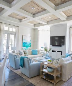 a living room filled with lots of furniture next to a fire place in a house