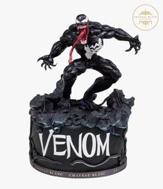 a statue of a spider man on top of a black base with the word venom