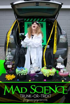 a woman standing in the trunk of a car with her mouth open and hands out