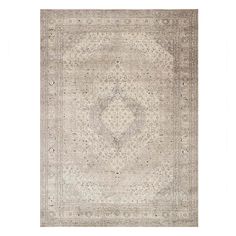 an antique rug with a medallion design on the center, in grey and beige tones