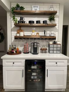 a kitchen with white cabinets and open shelves