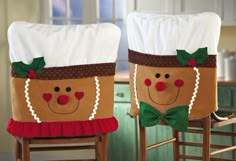 two kitchen chairs decorated with christmas themed decorations and bows on the back, one has a face