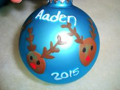 a blue ornament with reindeer heads on it's side and the year 2013