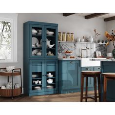 a kitchen with blue cabinets and marble counter tops