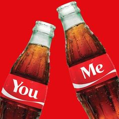 two bottles of soda with the words you and me printed on them, against a red background