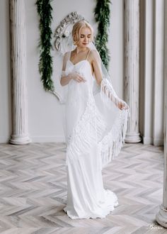 a woman in a white wedding dress and veil