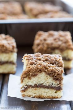 cinnamon crumb coffee cake is cut in half and stacked on top of each other