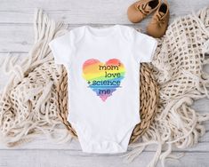 a baby bodysuit with the words dad love science me in rainbow colors on it