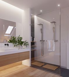 an image of a bathroom with white walls and wood flooring on the right side